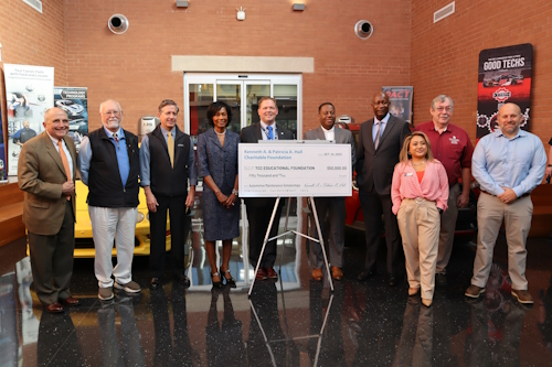 Group of people standing behind a donation check from the Kenneth A & Patricia A Hall Charitable Foundation